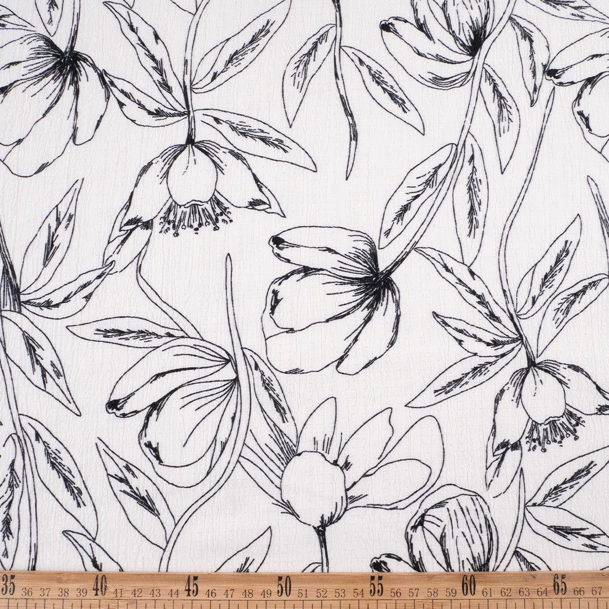 CREPE MARINA ESTAMPADO BLANCO ESTRELLA FLORAL EN LINEAS NEGRAS